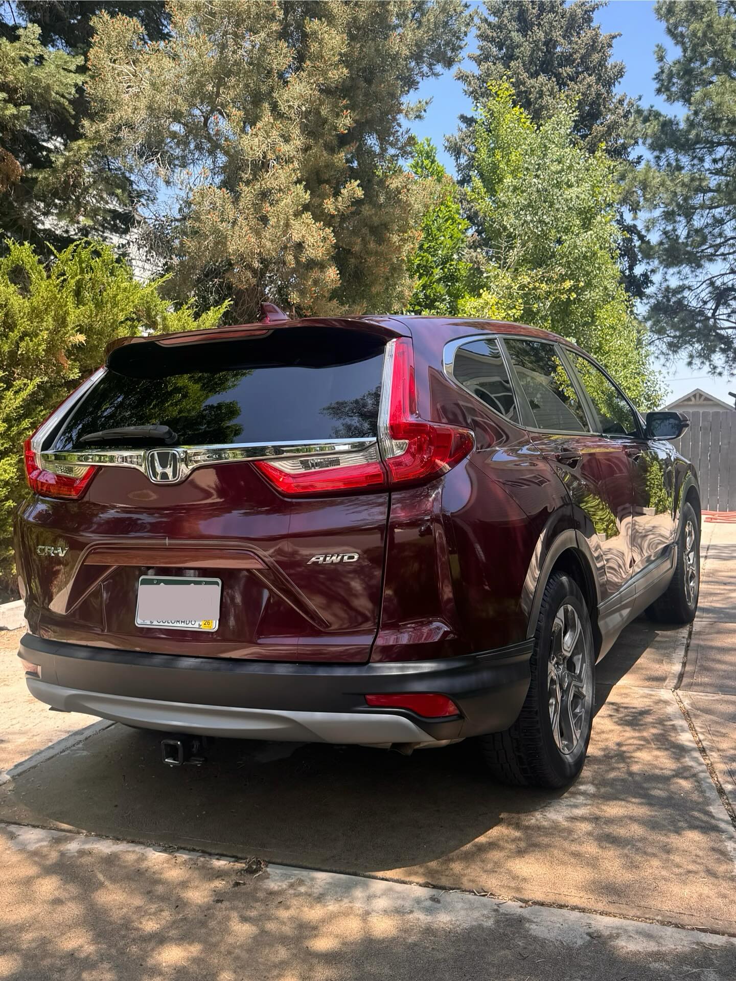 Maroon SUV after a full wash, rear view