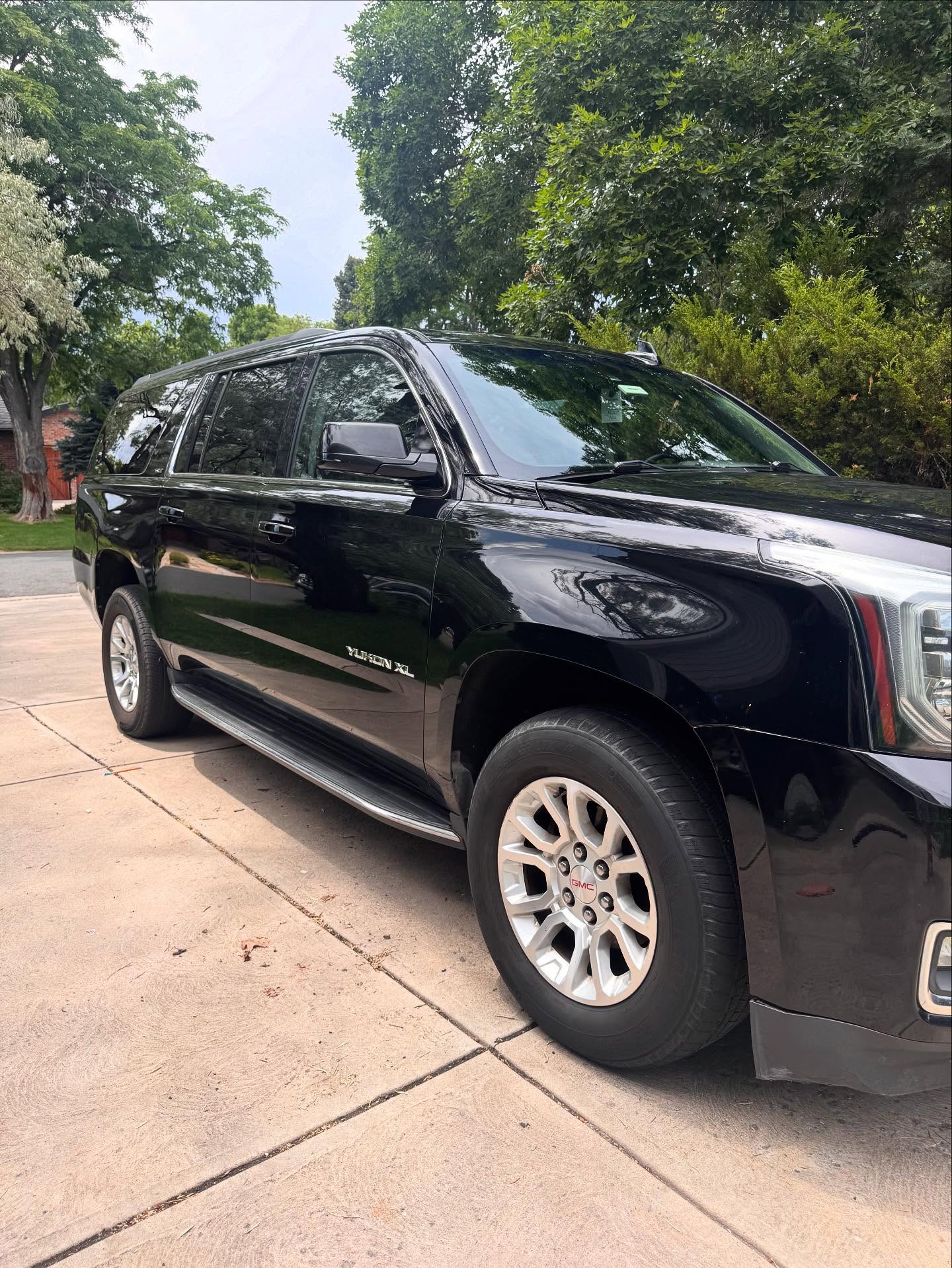 Black full-size SUV, detailed exterior, rear view