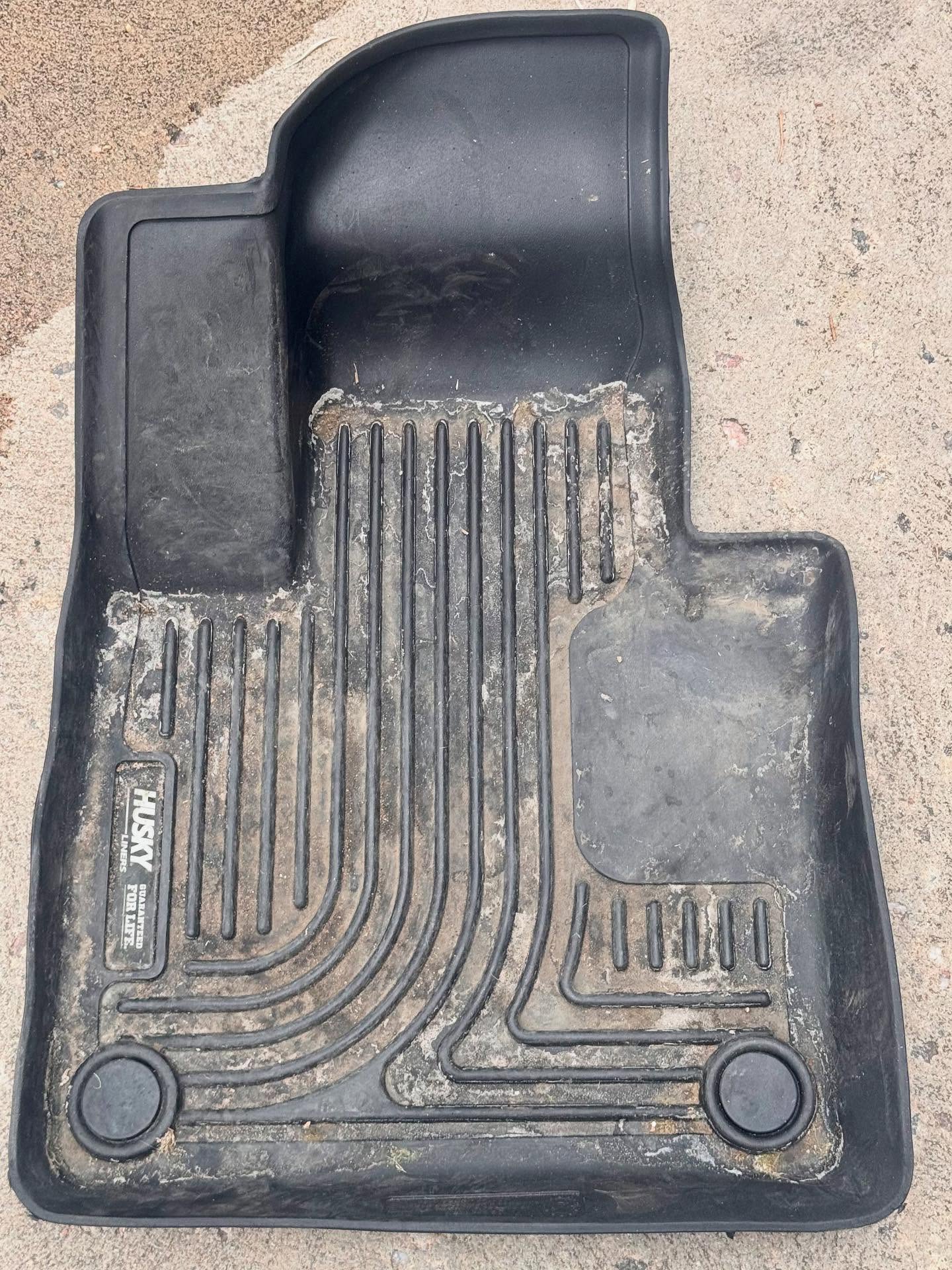 Filthy floor mat caked in dirt